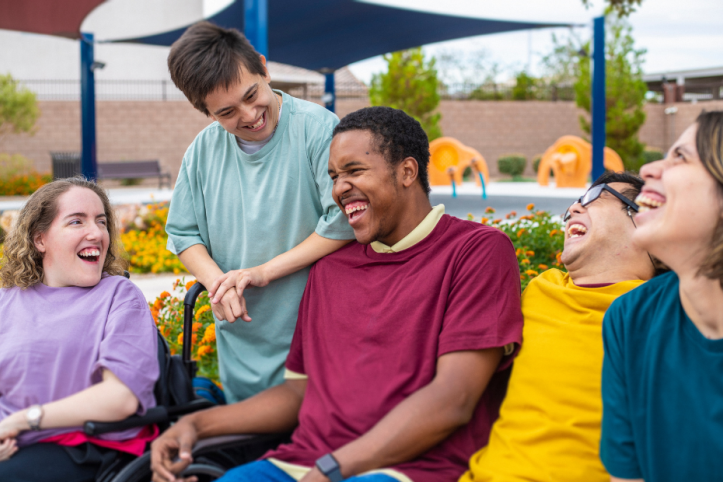 Disabled people laughing in a group.